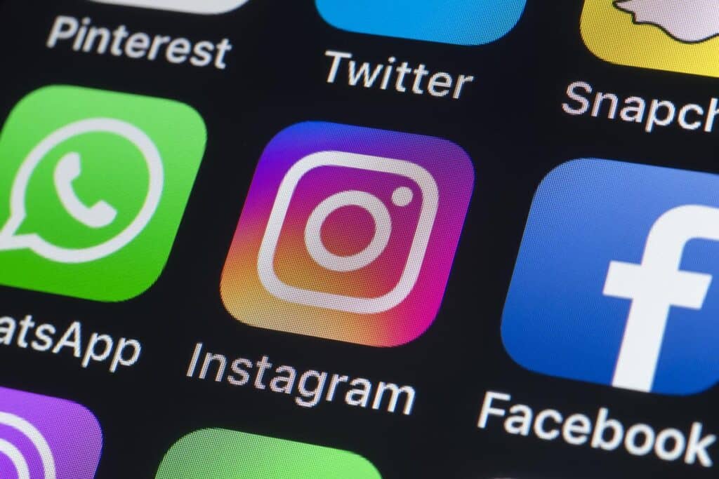facebook, instagram, and whatsapp on someone's iphone home screen