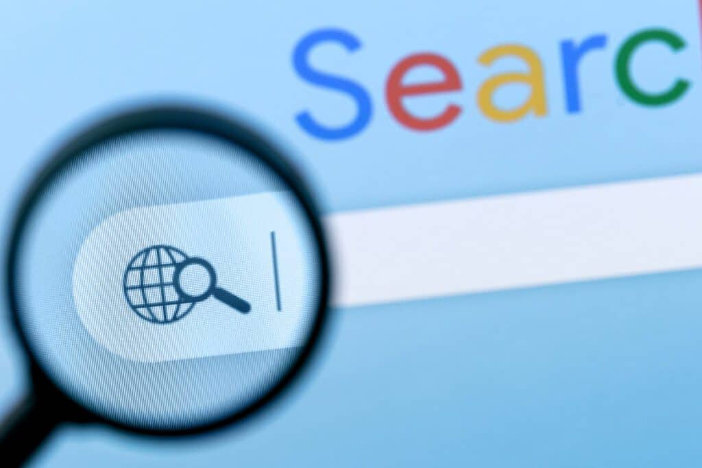 Internet search bar in browser with magnifier on computer monitor screen.