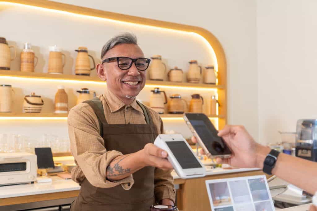man paying for products in a business